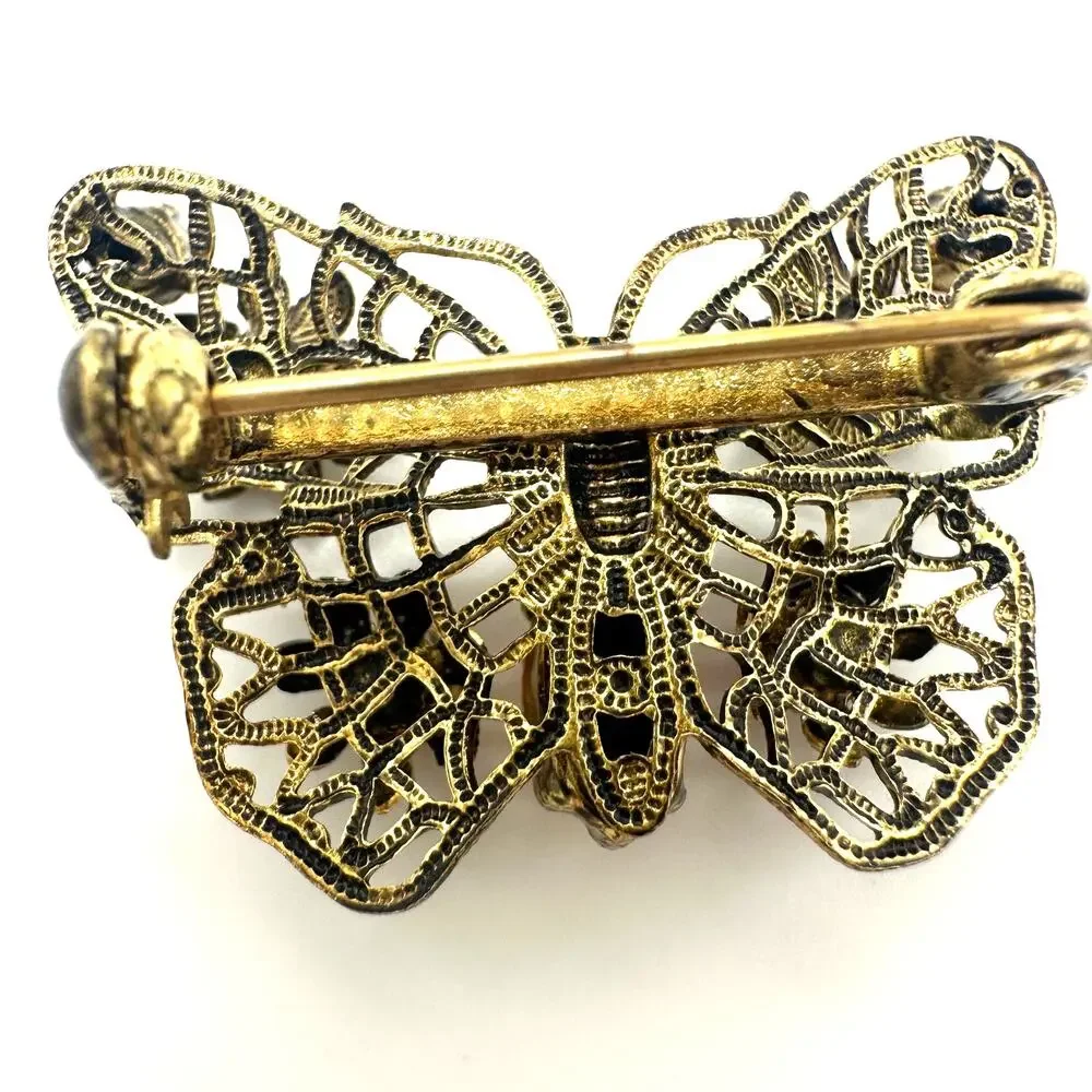 Vintage gold tone filigree multicolor prong set rhinestones butterfly brooch